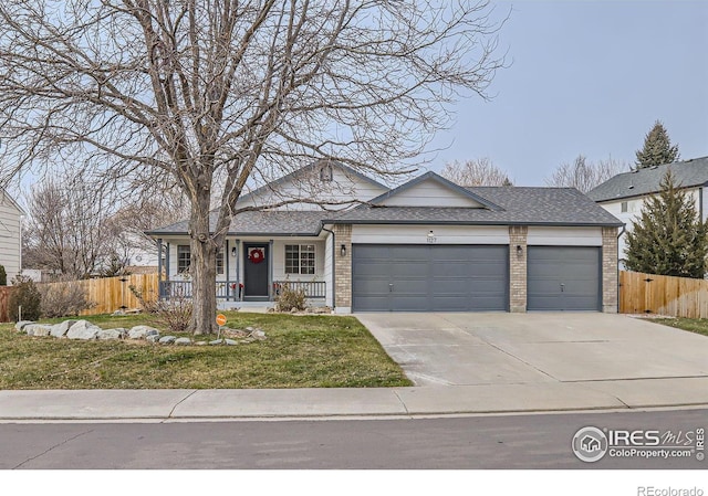 ranch-style home featuring covered porch, a garage, and a front lawn