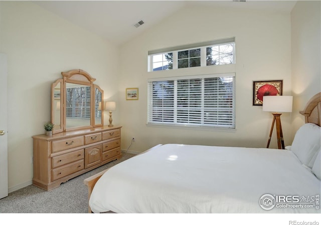 carpeted bedroom with lofted ceiling