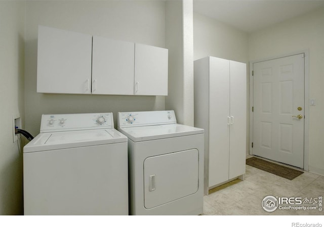 laundry area with cabinets and washing machine and clothes dryer