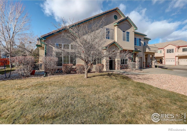 view of front of house with a front yard and a garage