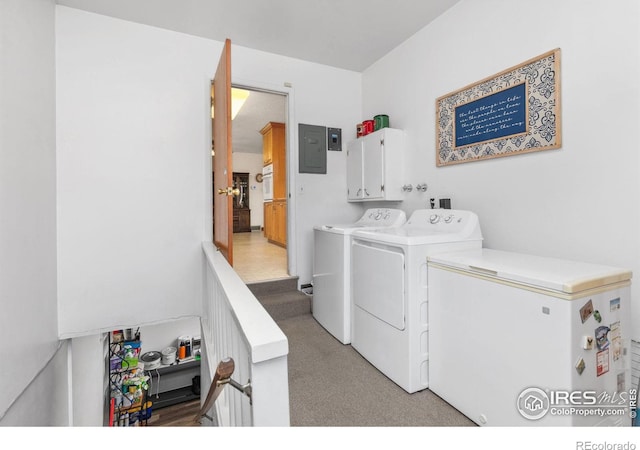 laundry room featuring cabinets, light carpet, electric panel, and washing machine and clothes dryer