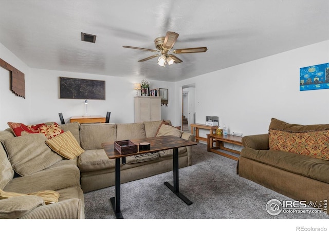 living room with ceiling fan and carpet floors