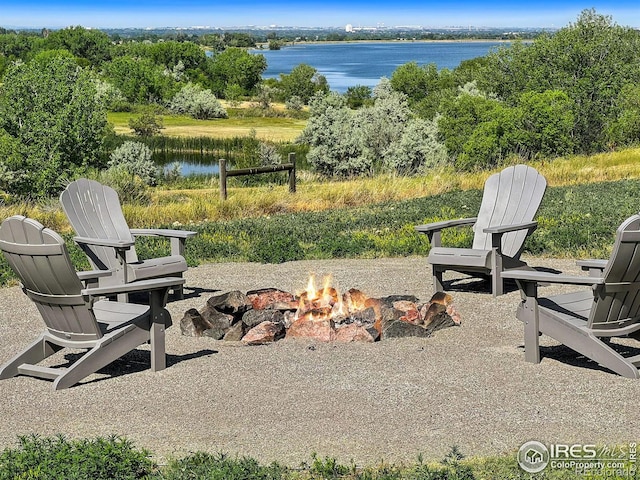 view of yard featuring a water view and a fire pit