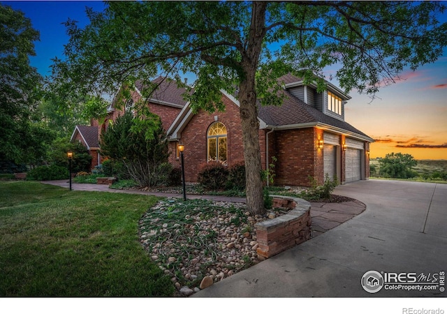 view of front of property featuring a garage and a yard