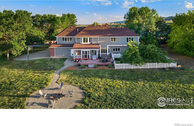 rear view of property with a yard and a wooden deck