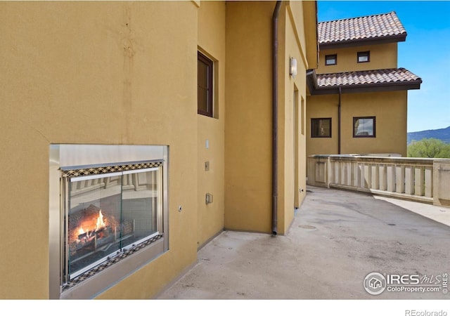 view of patio / terrace with a mountain view and an outdoor fireplace