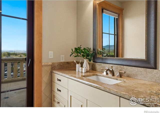 bathroom featuring plenty of natural light and vanity