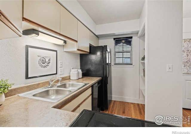 kitchen with dishwasher, hardwood / wood-style flooring, and sink