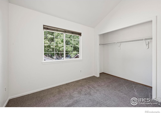 unfurnished bedroom featuring a closet, carpet floors, and vaulted ceiling