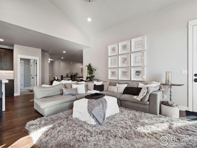 living room featuring dark hardwood / wood-style flooring and high vaulted ceiling