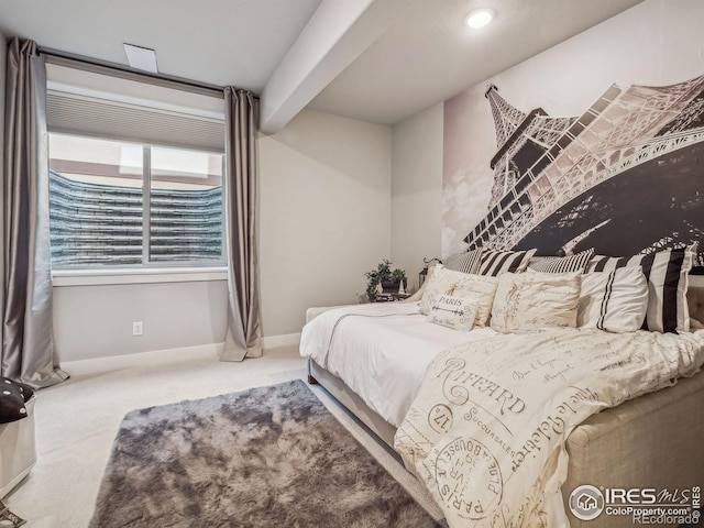 carpeted bedroom with beamed ceiling