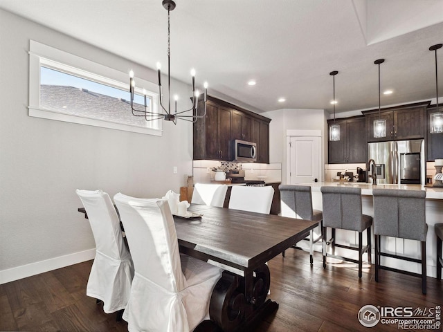 dining room featuring a notable chandelier and dark wood-type flooring