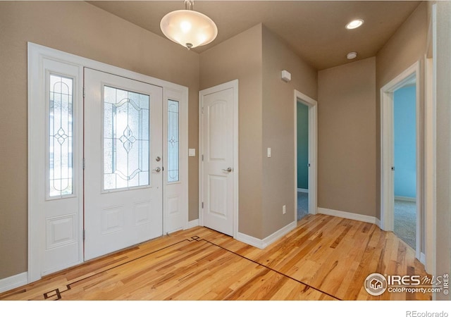 entryway featuring plenty of natural light and hardwood / wood-style flooring