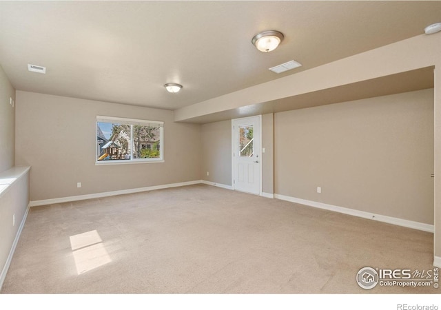 basement featuring light carpet