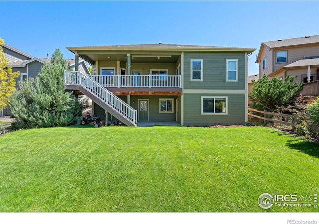 back of house featuring a yard and a wooden deck