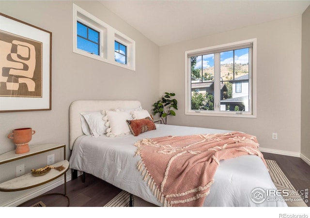 bedroom with dark wood-type flooring