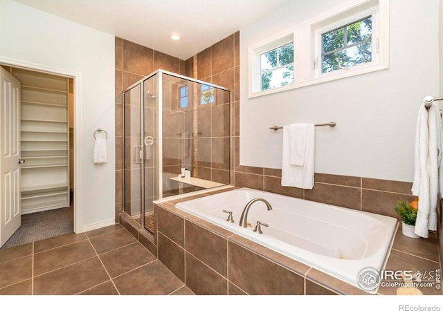 bathroom with tile patterned floors and separate shower and tub