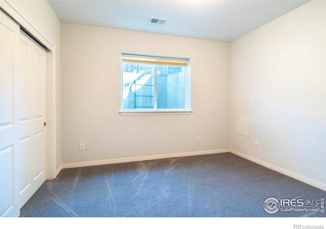 unfurnished bedroom featuring dark colored carpet