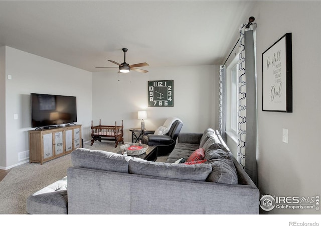 living room featuring carpet flooring and ceiling fan