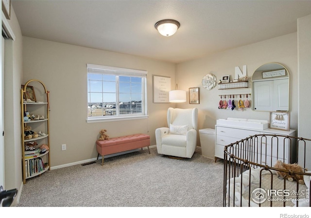 bedroom with carpet flooring and a nursery area