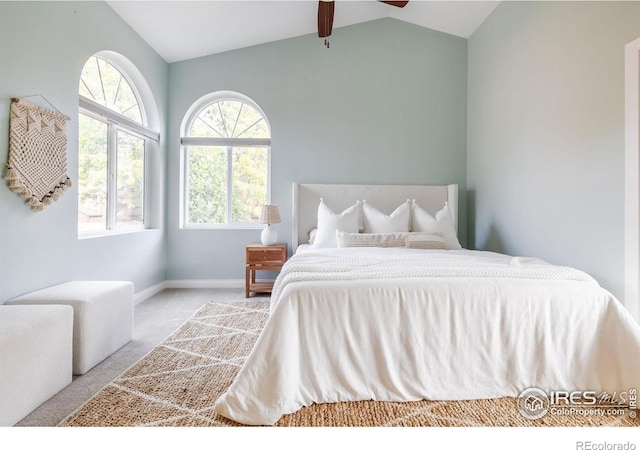 carpeted bedroom featuring vaulted ceiling, multiple windows, baseboards, and ceiling fan