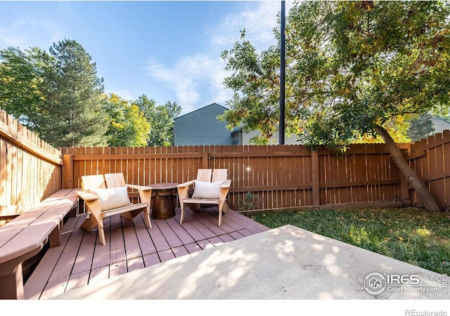 wooden terrace featuring a fenced backyard