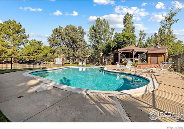community pool featuring a gazebo, a patio, and fence