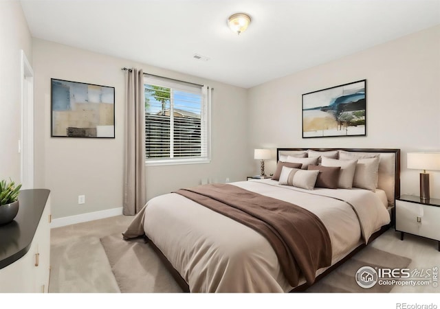 bedroom with light colored carpet