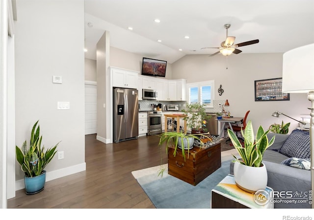 living room featuring ceiling fan, dark hardwood / wood-style flooring, and lofted ceiling