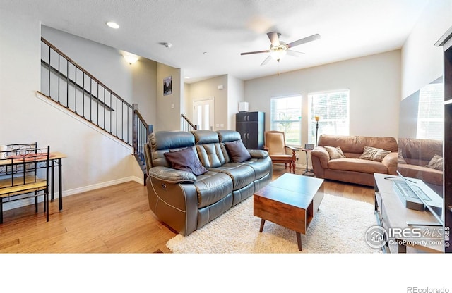 living room featuring ceiling fan and light hardwood / wood-style floors