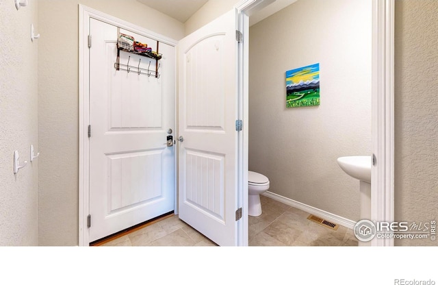 bathroom with tile patterned floors and toilet