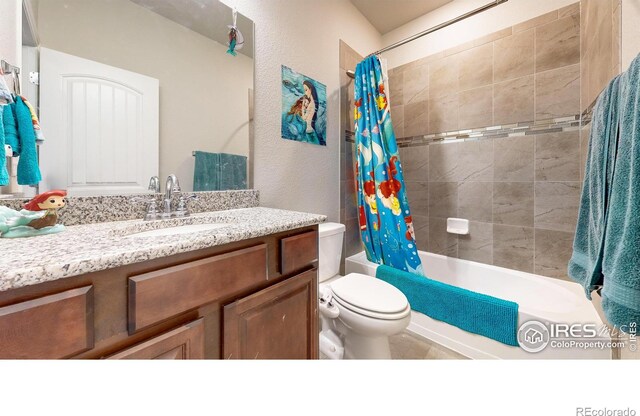 full bathroom featuring vanity, toilet, and shower / tub combo