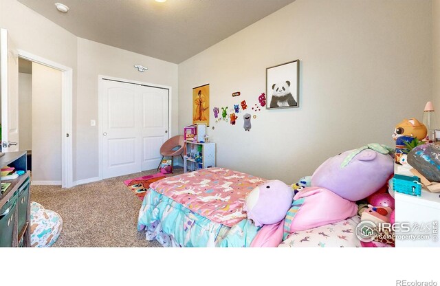 bedroom with lofted ceiling, carpet flooring, and a closet