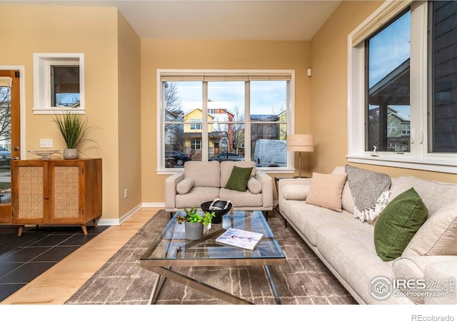 living area with dark wood-type flooring and baseboards