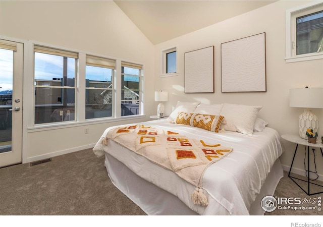 carpeted bedroom featuring baseboards, visible vents, and vaulted ceiling