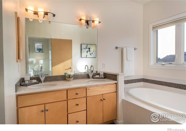 bathroom featuring vanity and a relaxing tiled tub