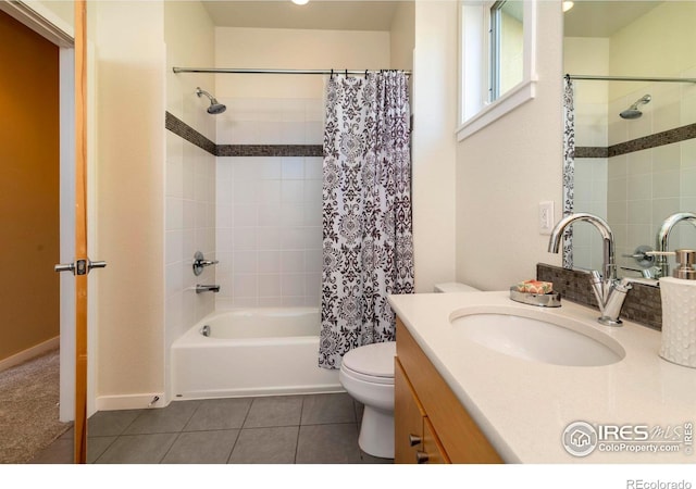 bathroom featuring shower / bathtub combination with curtain, vanity, toilet, and tile patterned floors