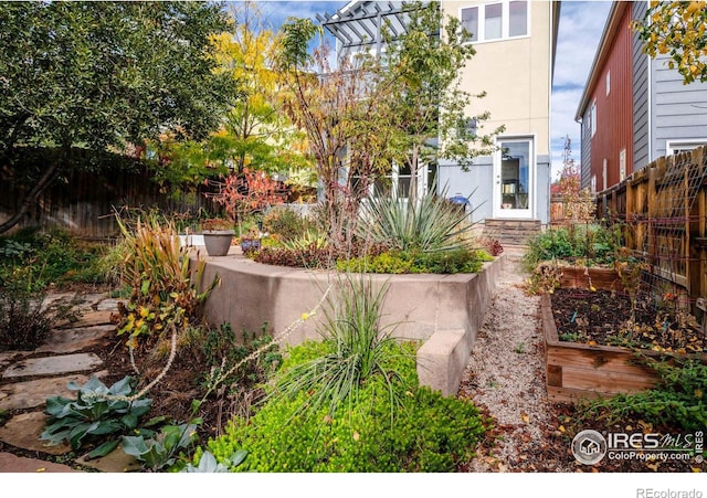 view of yard featuring a vegetable garden and fence