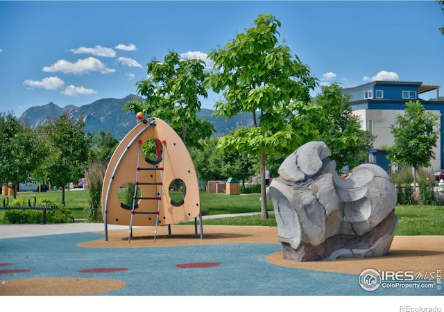 view of community featuring playground community and a mountain view