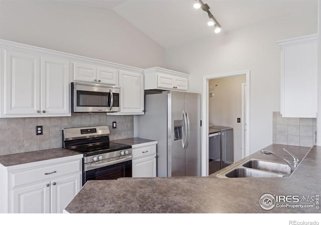 kitchen with white cabinets, separate washer and dryer, sink, and appliances with stainless steel finishes