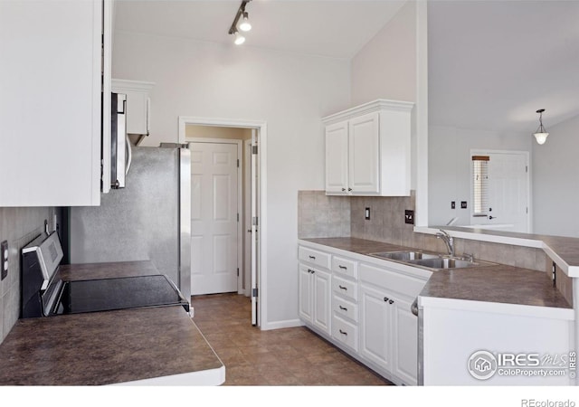 kitchen with kitchen peninsula, stove, sink, white cabinetry, and hanging light fixtures