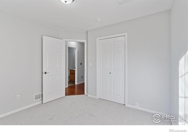 unfurnished bedroom with carpet and a closet