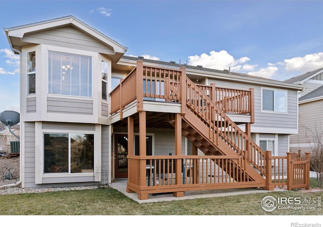 back of property with central AC unit and a deck