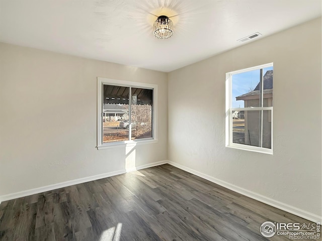 empty room with dark hardwood / wood-style flooring