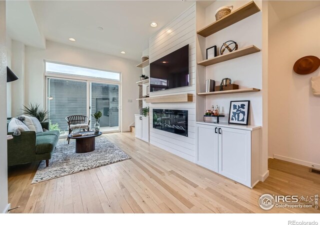1998 Foxtail Ln Unit B, Lafayette, CO 80026 - living room featuring light wood-style floors, a glass covered fireplace, recessed lighting, and baseboards