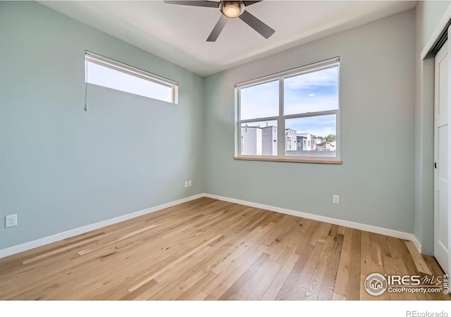 1998 Foxtail Ln Unit B, Lafayette, CO 80026 - unfurnished bedroom with multiple windows, wood-type flooring, and baseboards