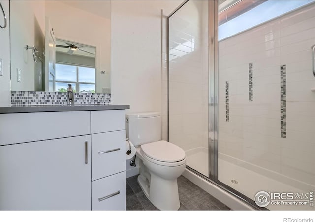 1998 Foxtail Ln Unit B, Lafayette, CO 80026 - bathroom featuring a stall shower, a ceiling fan, toilet, vanity, and decorative backsplash