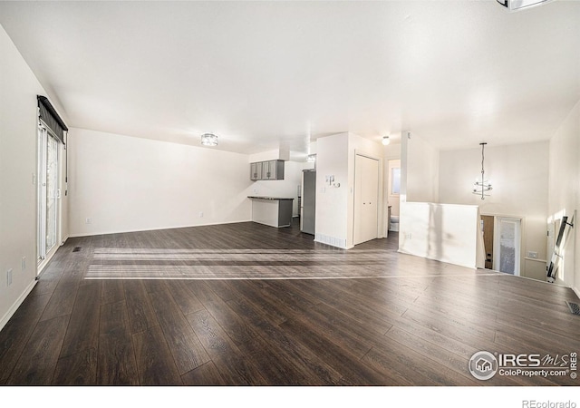 unfurnished living room with dark wood-type flooring