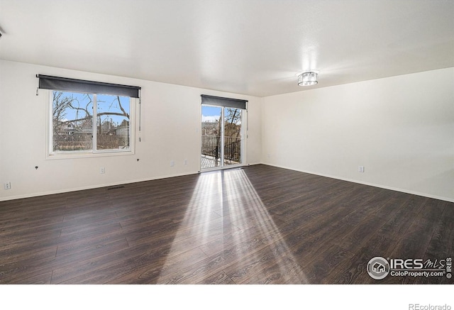 spare room featuring dark hardwood / wood-style floors