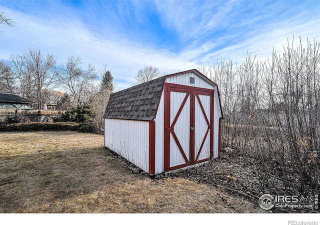 view of outbuilding with a yard